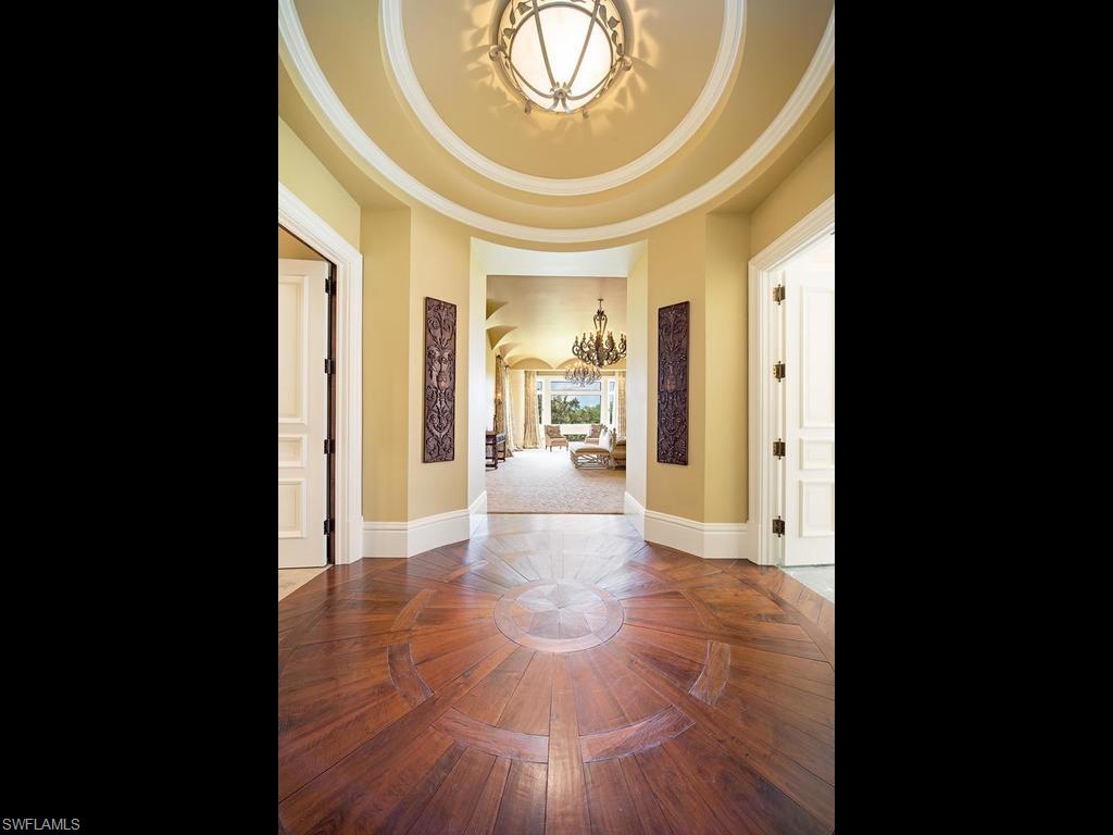 9766 Bent Grass Bend Naples, FL 34108 - Photo 19 of 35 a view of a hallway view with wooden floor and a dining table