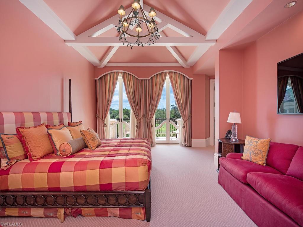 9766 Bent Grass Bend Naples, FL 34108 - Photo 24 of 35 a bedroom with a bed and a couch