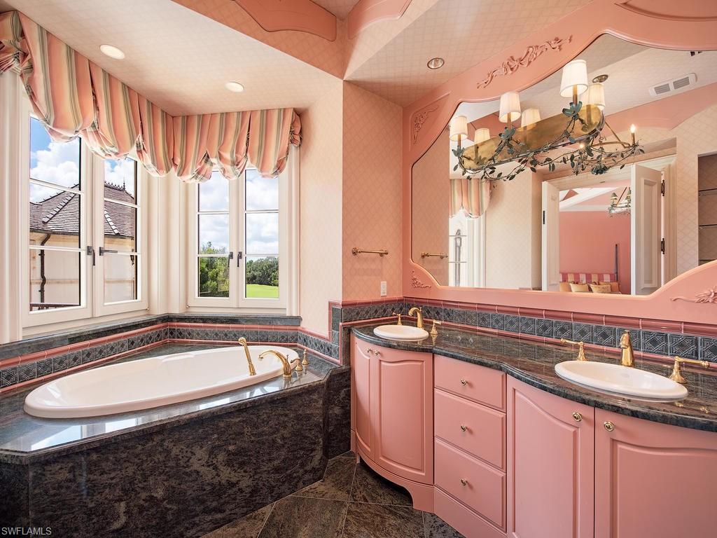 9766 Bent Grass Bend Naples, FL 34108 - Photo 27 of 35 a bathroom with a granite countertop sink and a bathtub