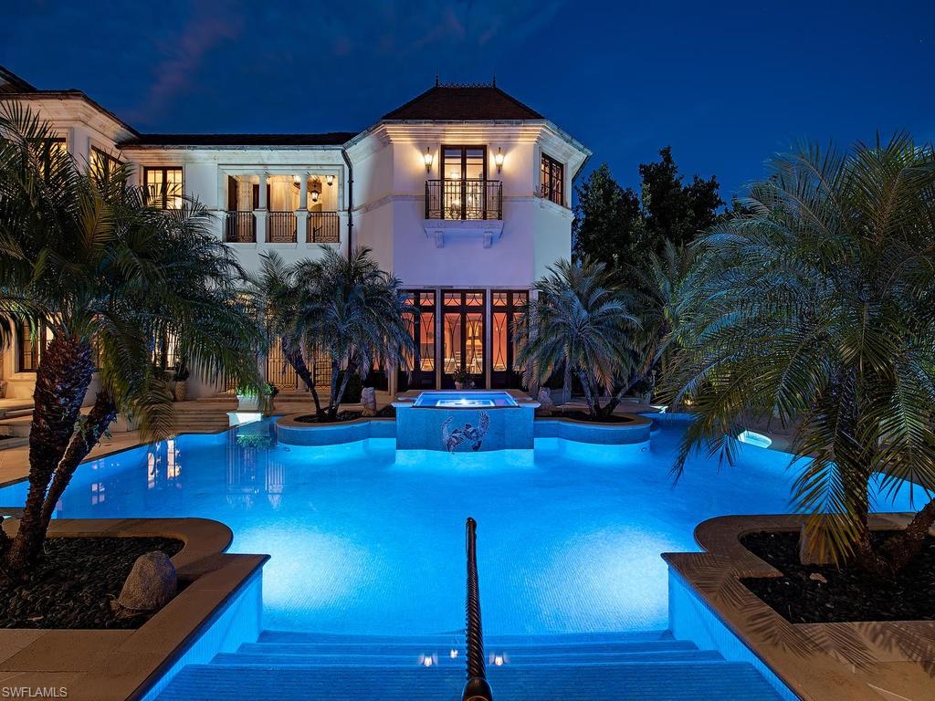 9766 Bent Grass Bend Naples, FL 34108 - Photo 29 of 35 a living room with furniture and a fireplace