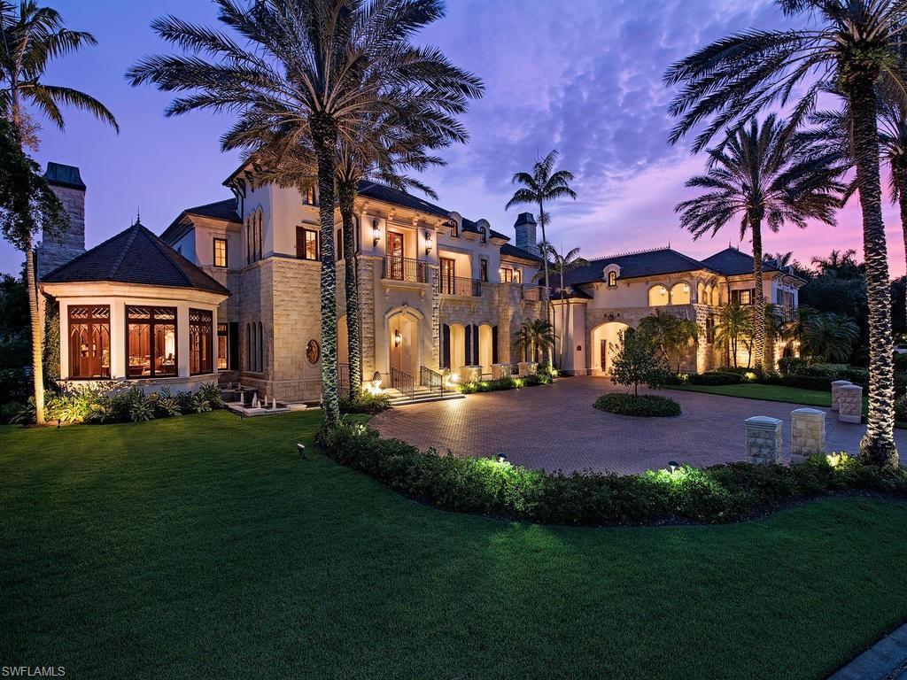 9766 Bent Grass Bend Naples, FL 34108 - Photo 30 of 35 a front view of a house with garden and patio
