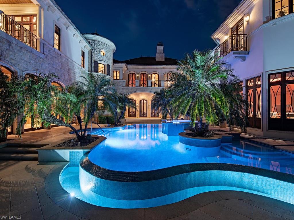 9766 Bent Grass Bend Naples, FL 34108 - Photo 32 of 35 a swimming pool with outdoor seating yard and barbeque oven