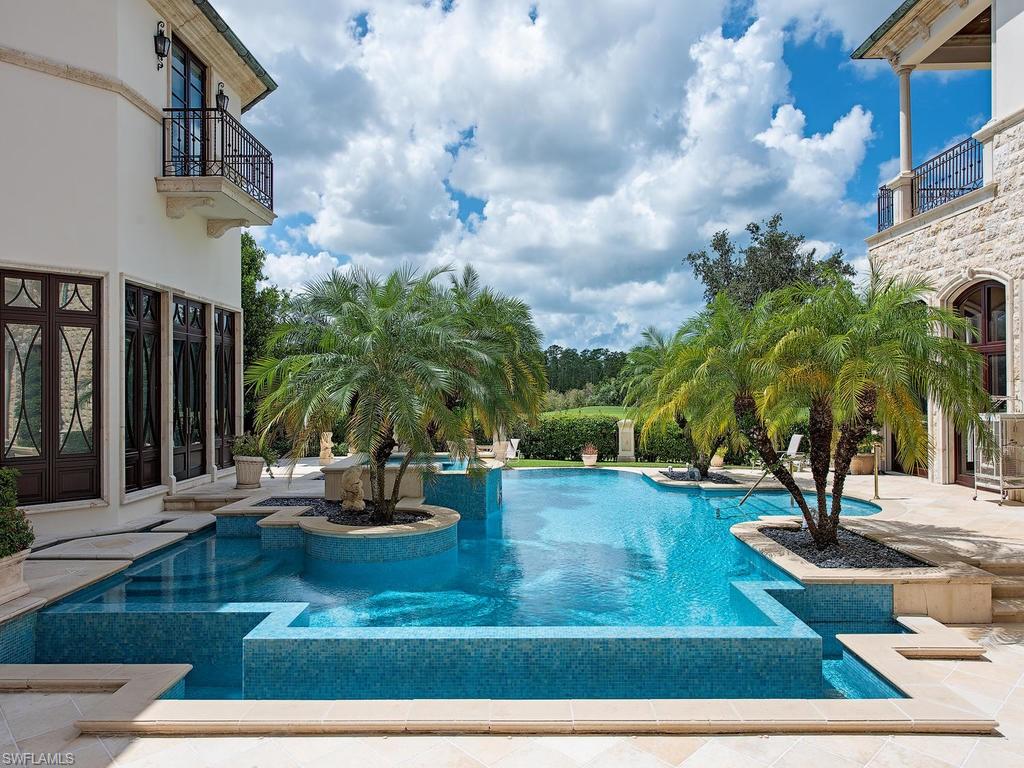 9766 Bent Grass Bend Naples, FL 34108 - Photo 34 of 35 a view of a swimming pool with a patio