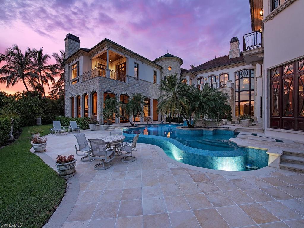 9766 Bent Grass Bend Naples, FL 34108 - Photo 4 of 35 a view of a building with a swimming pool and sitting area