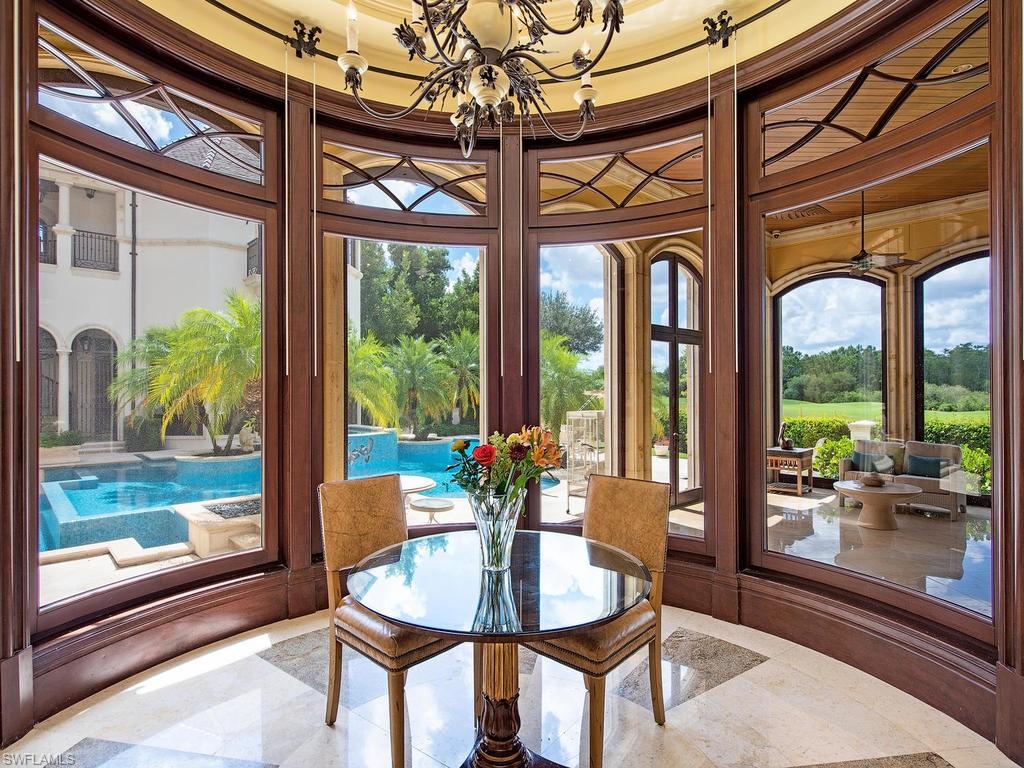 9766 Bent Grass Bend Naples, FL 34108 - Photo 10 of 35 a dining room with glass windows and wooden floor