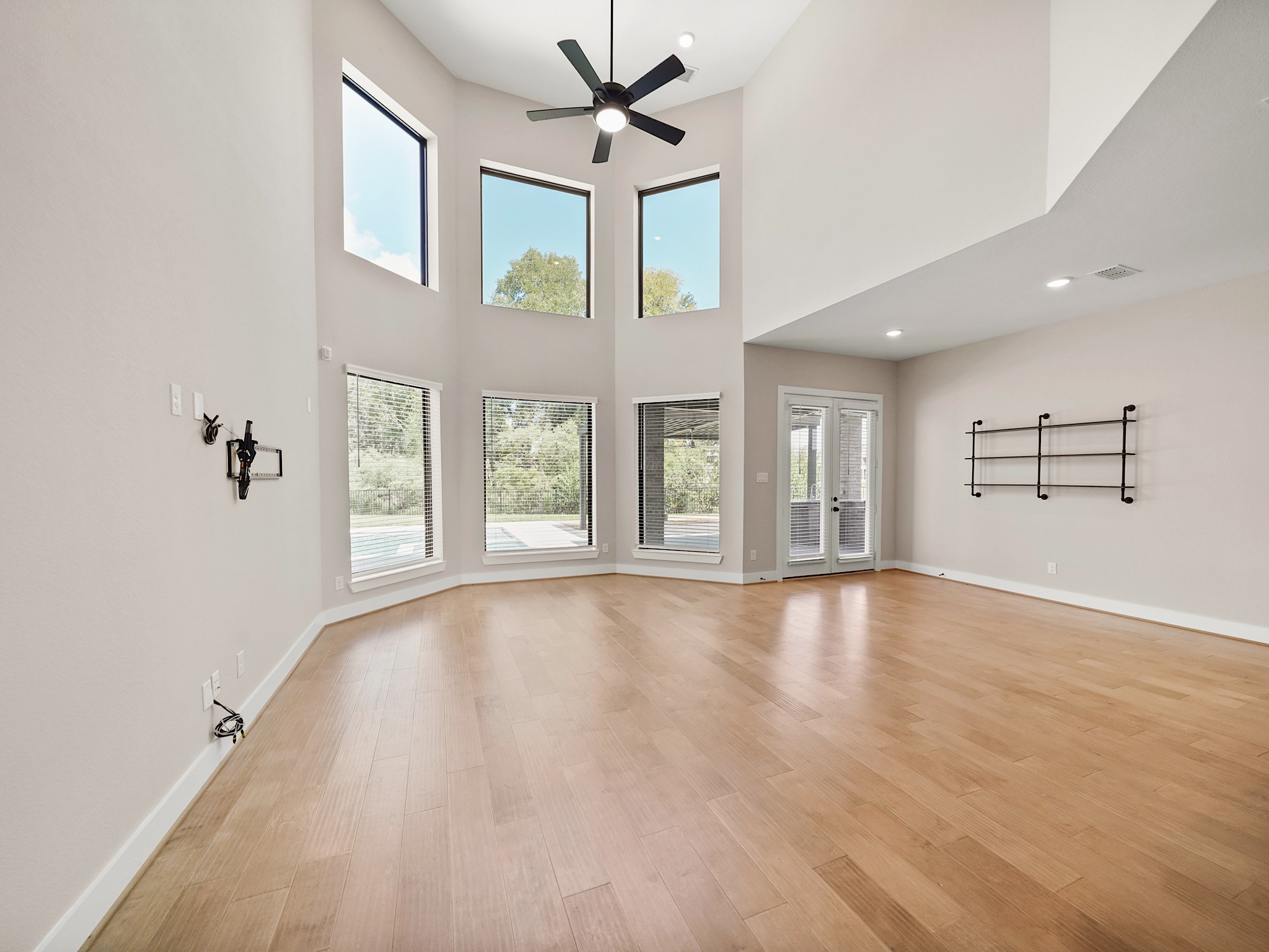 30214 Crossfield Road Fulshear, TX 77441 - Photo 14 of 42 The unfurnished view underscores the family room’s impressive proportions, architectural ceiling height, and flexibility for a layered furniture plan.