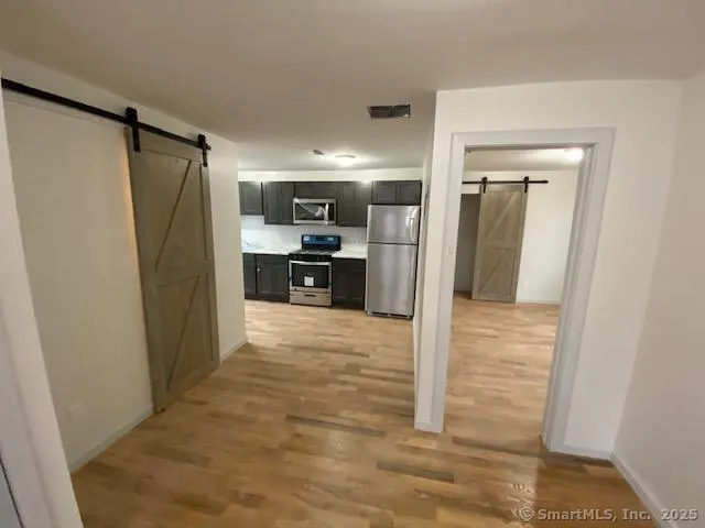 a view of a kitchen from the hallway