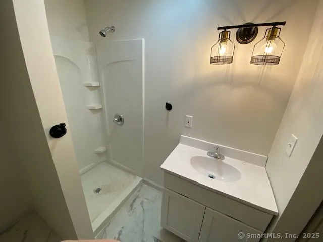 a bathroom with a sink and shower