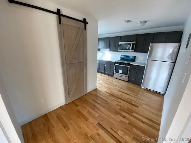 a kitchen with stainless steel appliances a refrigerator and a stove top oven