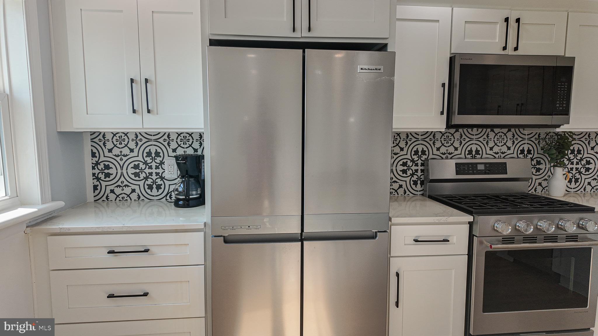 3503 Brookview Road Philadelphia, PA 19154 - Photo 11 of 30 a kitchen with stainless steel appliances white cabinets and a stove