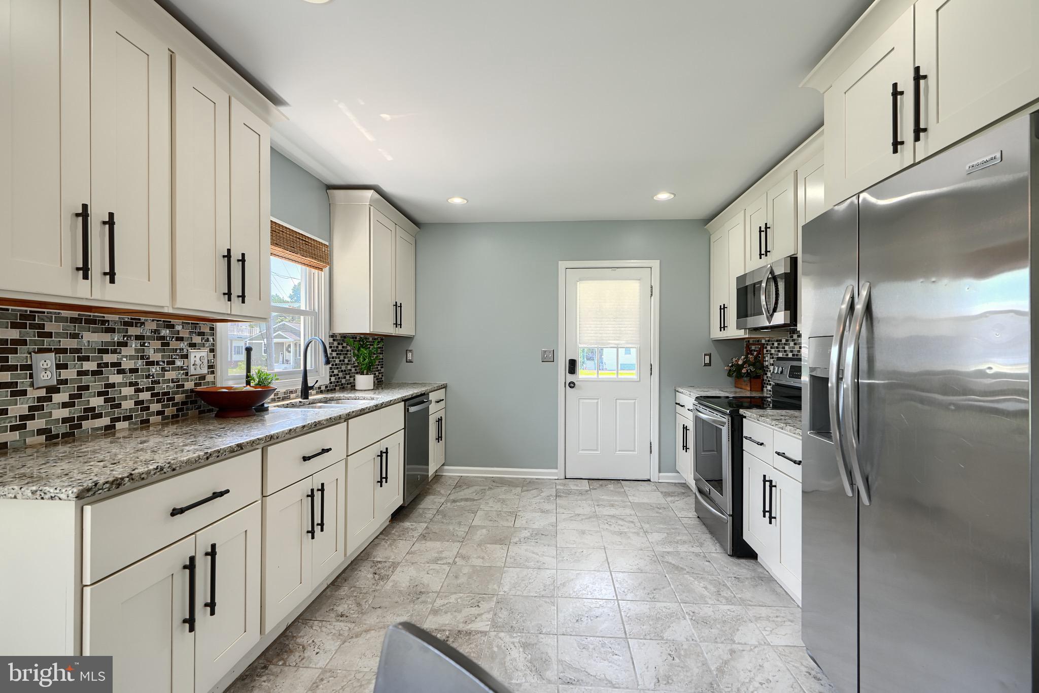 2903 Sparrows Point Road Sparrows Point, MD 21219 - Photo 15 of 57 a large kitchen with stainless steel appliances granite countertop a stove a sink and a refrigerator