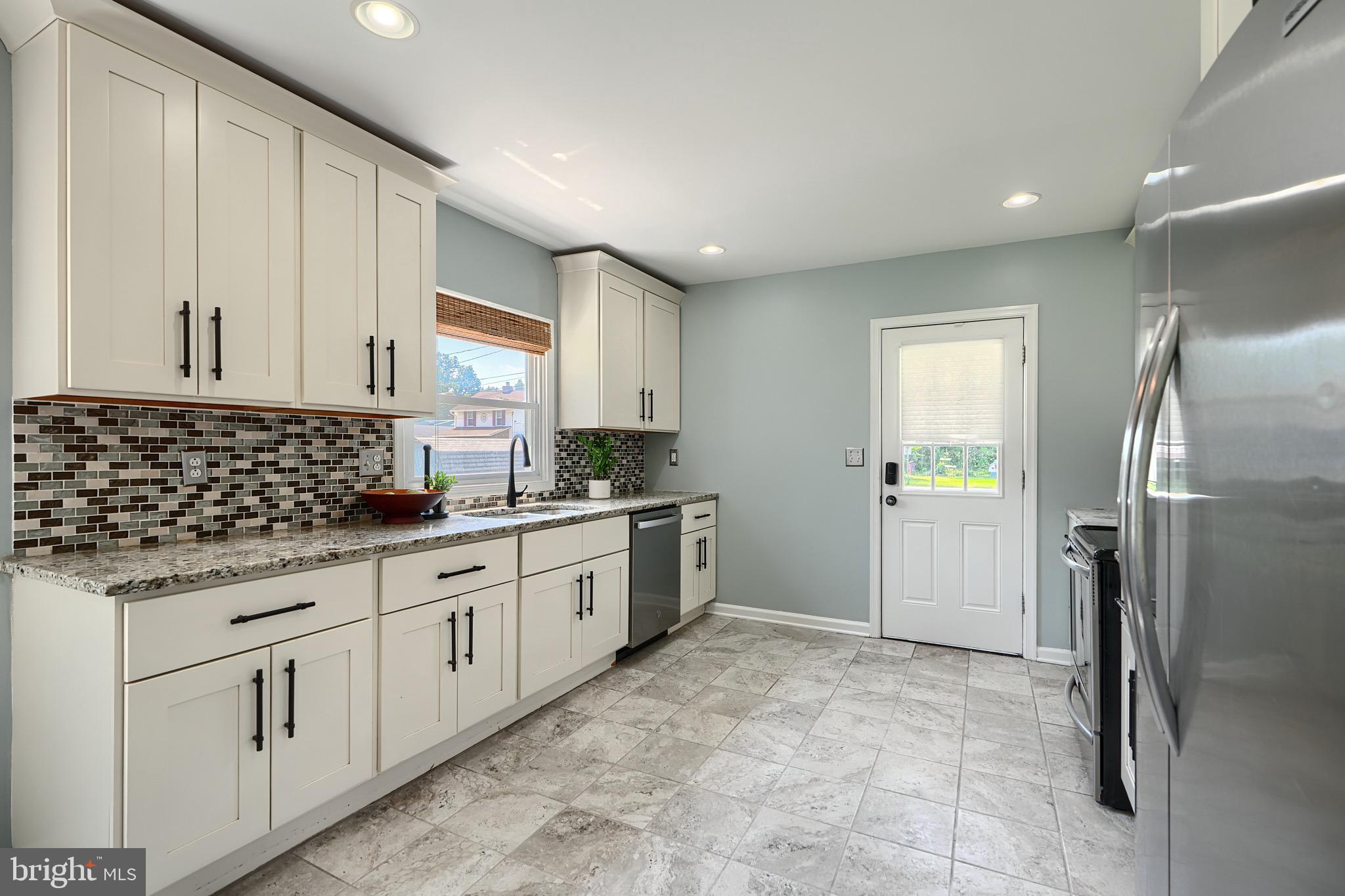 2903 Sparrows Point Road Sparrows Point, MD 21219 - Photo 16 of 57 a kitchen with granite countertop a refrigerator and a sink