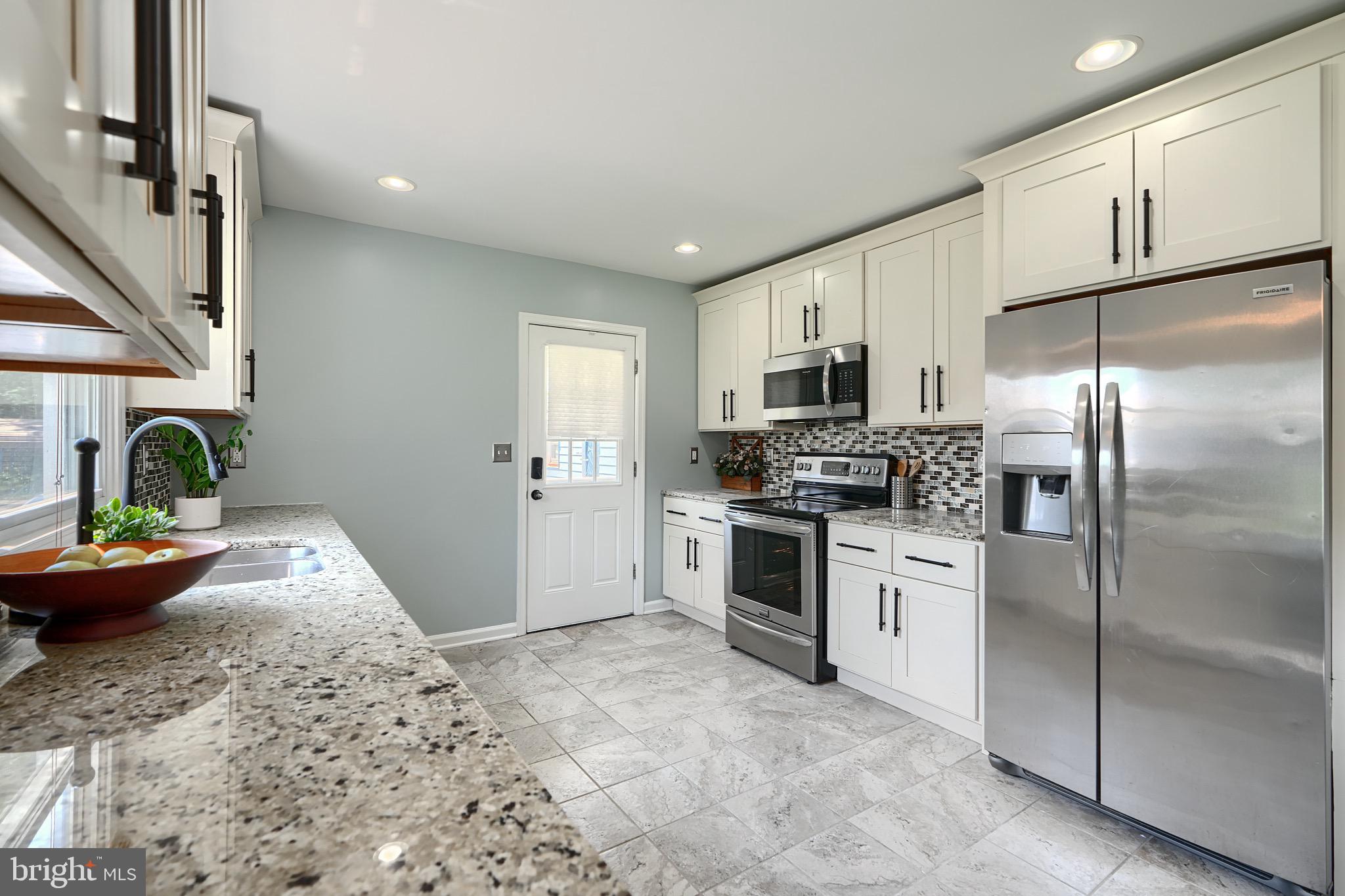 2903 Sparrows Point Road Sparrows Point, MD 21219 - Photo 17 of 57 a kitchen with granite countertop stainless steel appliances and wooden cabinets