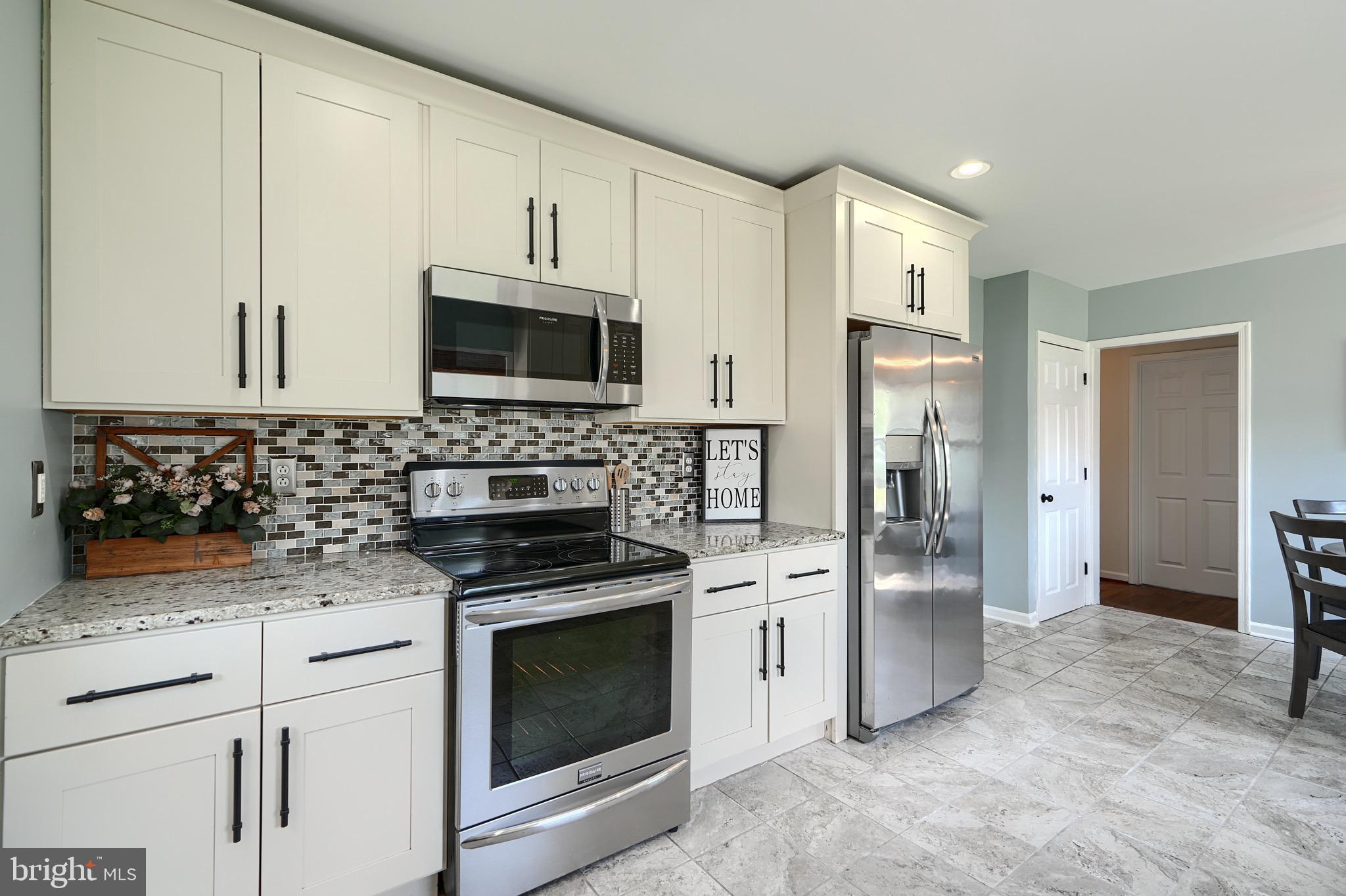 2903 Sparrows Point Road Sparrows Point, MD 21219 - Photo 18 of 57 a kitchen with white cabinets and stainless steel appliances