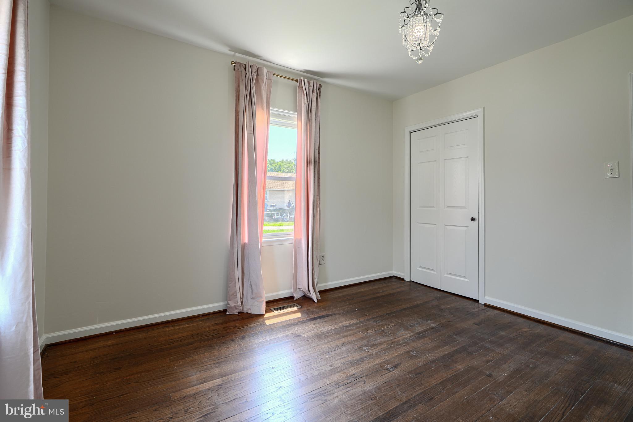 2903 Sparrows Point Road Sparrows Point, MD 21219 - Photo 26 of 57 an empty room with wooden floor and windows