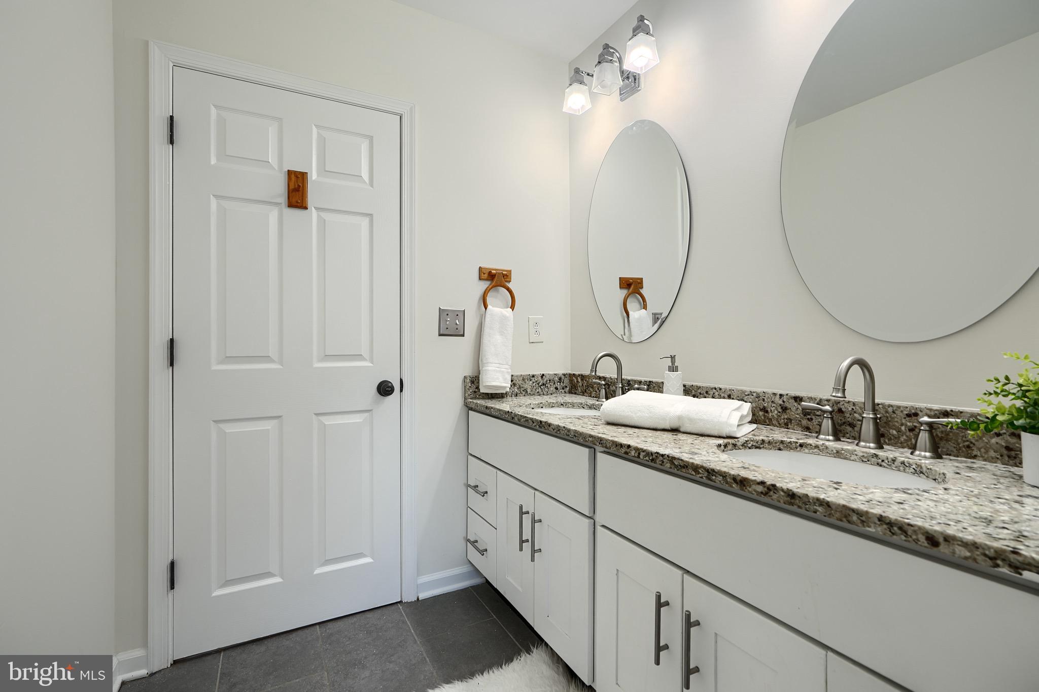 2903 Sparrows Point Road Sparrows Point, MD 21219 - Photo 28 of 57 a en suite bathroom with a double vanity sink and a mirror