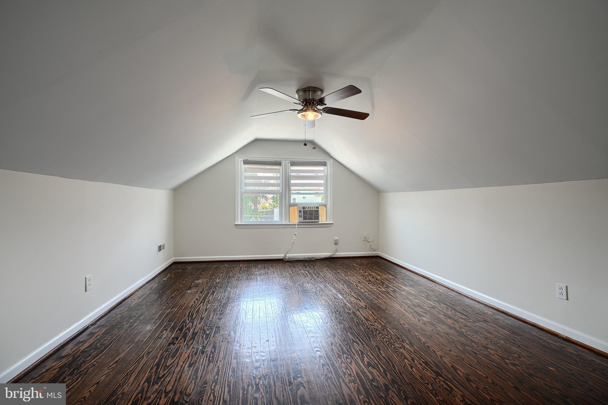 2903 Sparrows Point Road Sparrows Point, MD 21219 - Photo 33 of 57 an empty room with wooden floor chandelier fan and windows