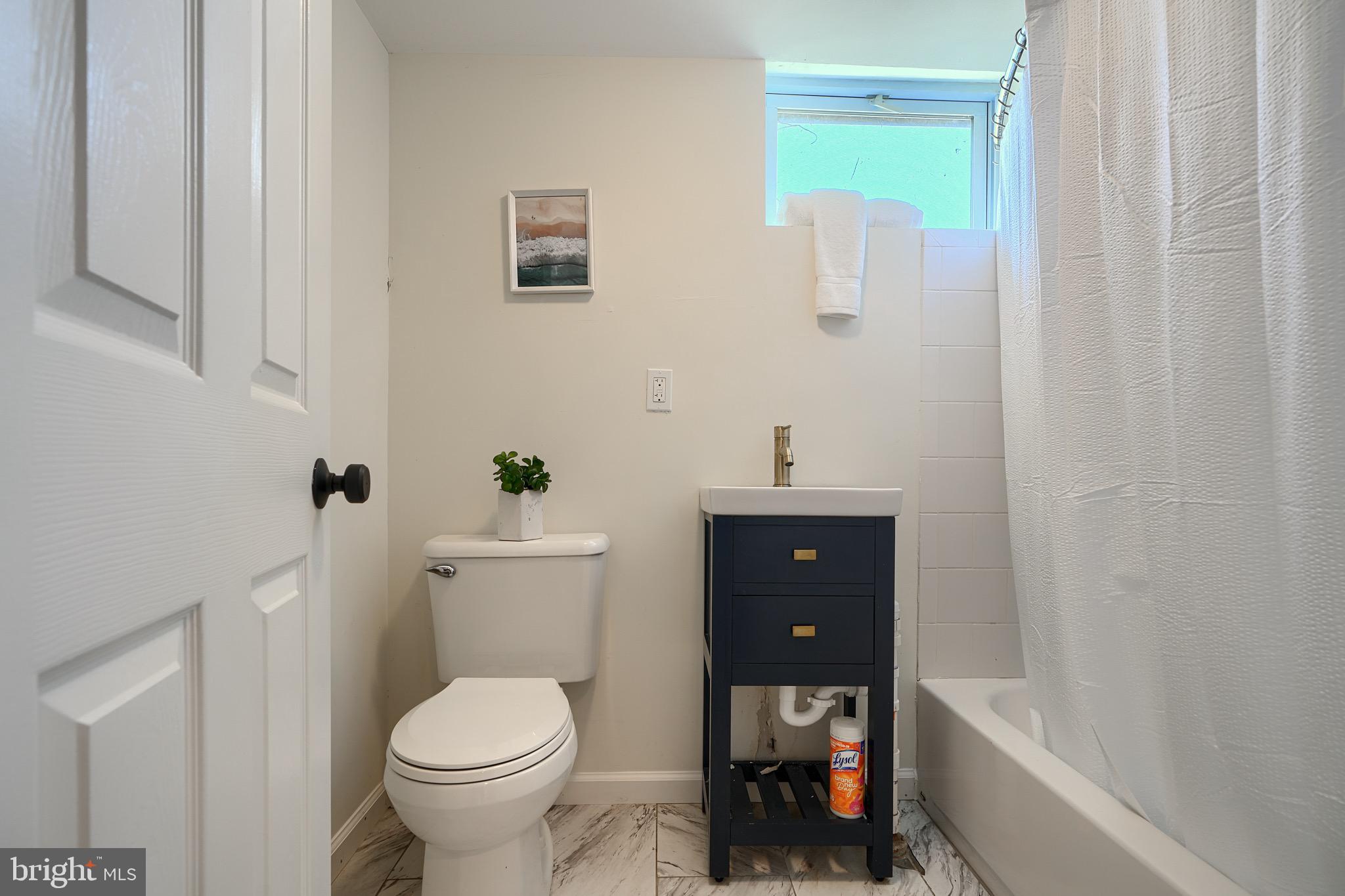 2903 Sparrows Point Road Sparrows Point, MD 21219 - Photo 46 of 57 a bathroom with a toilet a sink and tub