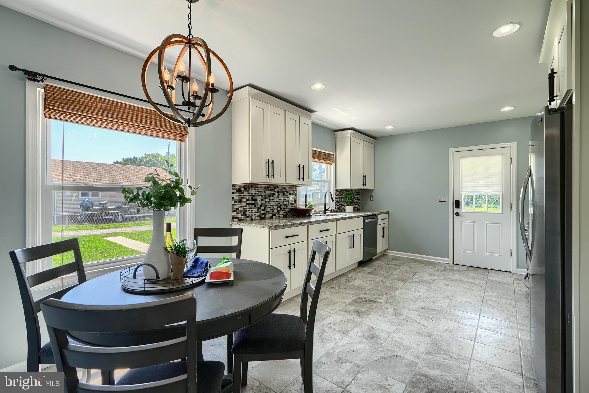 2903 Sparrows Point Road Sparrows Point, MD 21219 - Photo 10 of 57 a kitchen with kitchen island a table and chairs in it