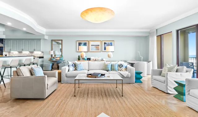 a living room with furniture a flat screen tv and a window