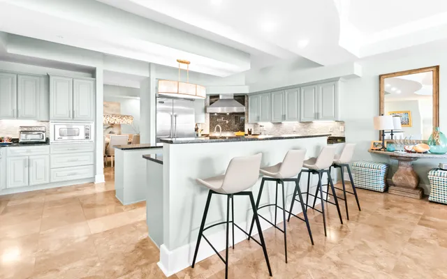 a kitchen with a table chairs and a view of living room