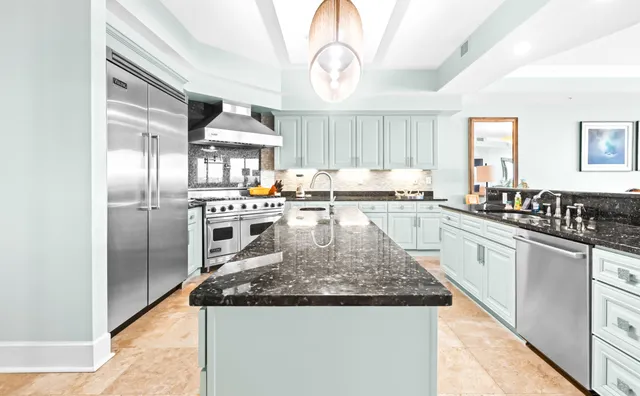 a bedroom with a bed a flat screen tv and a couch