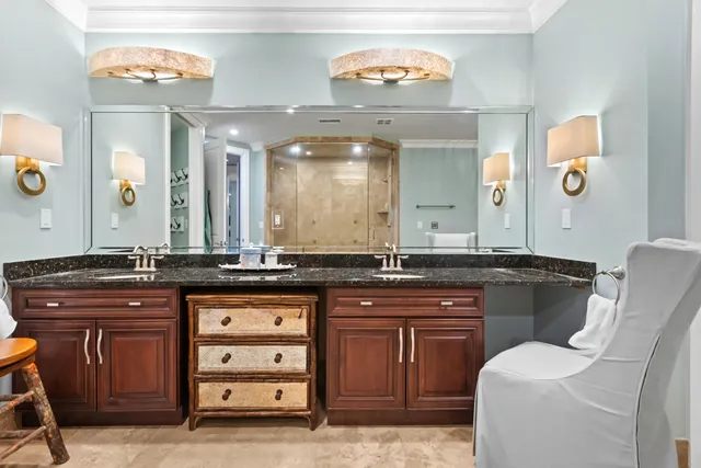 a living room with furniture a large window and a chandelier