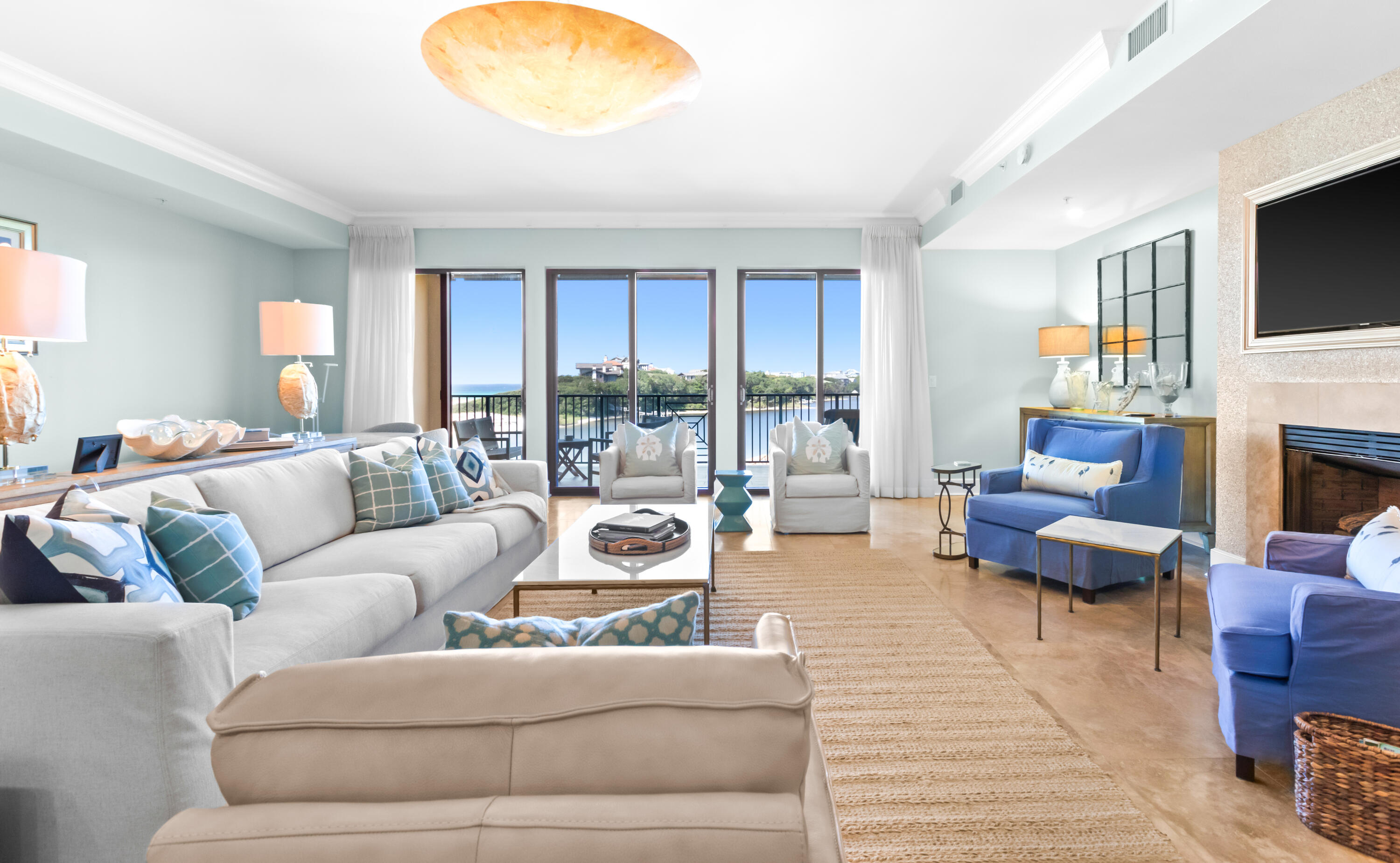 1363 West County Highway 30A, Unit 2120 Santa Rosa Beach, FL 32459 - Photo 5 of 107 a living room with furniture a fireplace and a flat screen tv