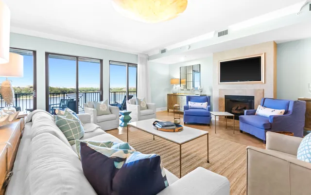 a living room with furniture a flat screen tv and a fireplace