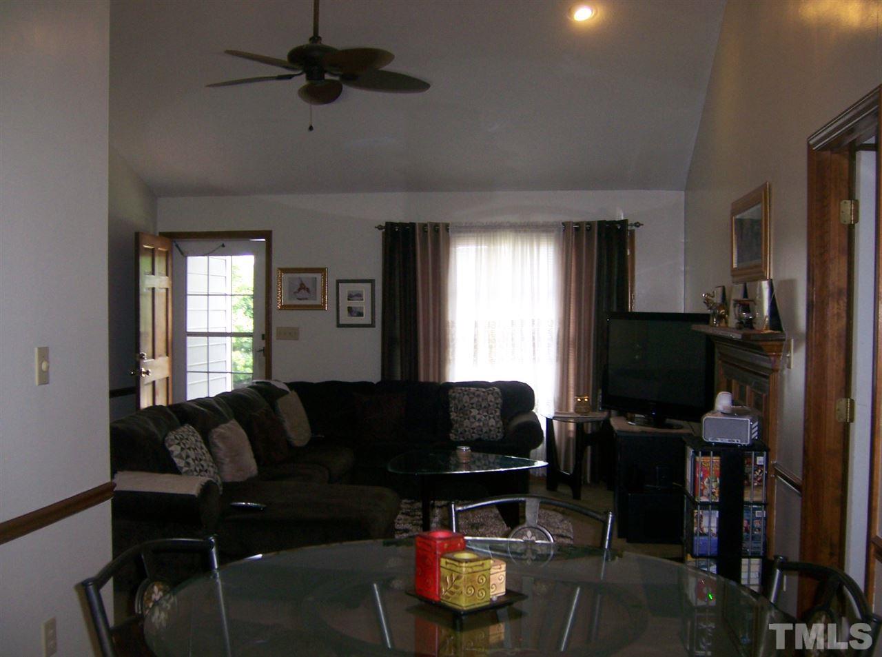 5248 Turf Grass Court Raleigh, NC 27610 - Photo 2 of 7 a living room with furniture a window and a flat screen tv