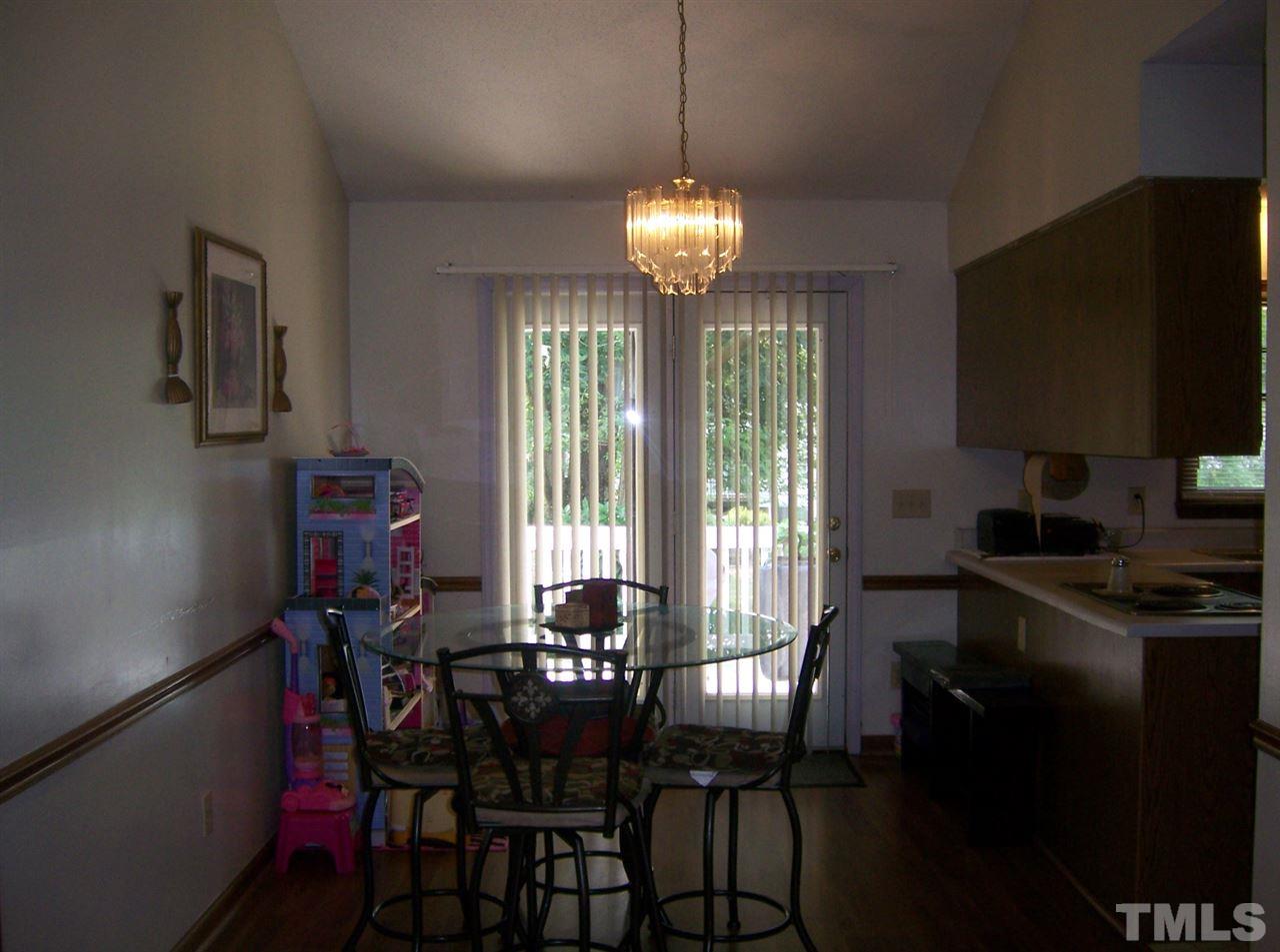 5248 Turf Grass Court Raleigh, NC 27610 - Photo 3 of 7 a view of a dining room with furniture window and outside view