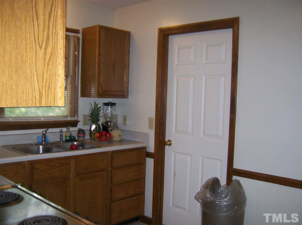5248 Turf Grass Court Raleigh, NC 27610 - Photo 5 of 7 a kitchen with a sink and a window