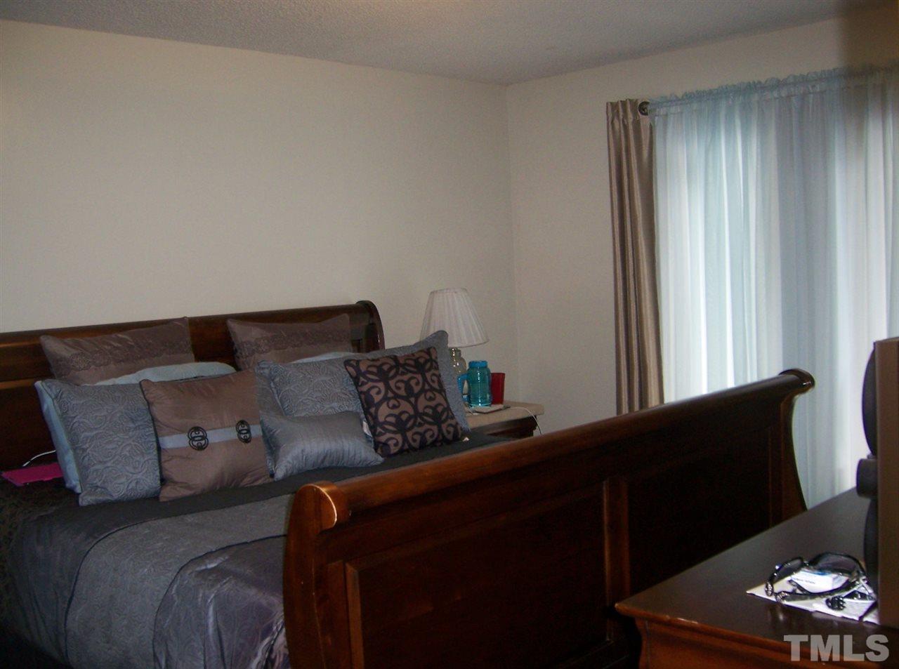 5248 Turf Grass Court Raleigh, NC 27610 - Photo 6 of 7 a bed sitting in a bedroom next to a window