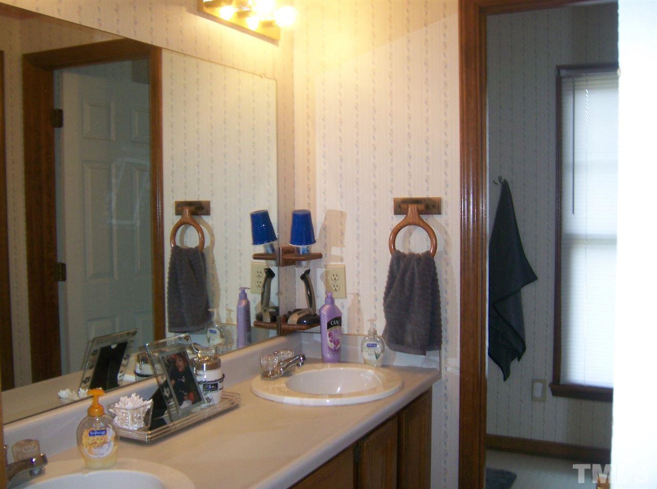 5248 Turf Grass Court Raleigh, NC 27610 - Photo 7 of 7 a bathroom with double vanity sinks and a mirror