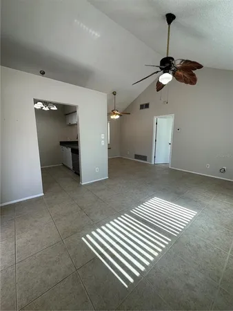 a view of empty room with a ceiling fan