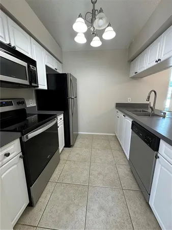 a kitchen with stainless steel appliances granite countertop a sink and a stove