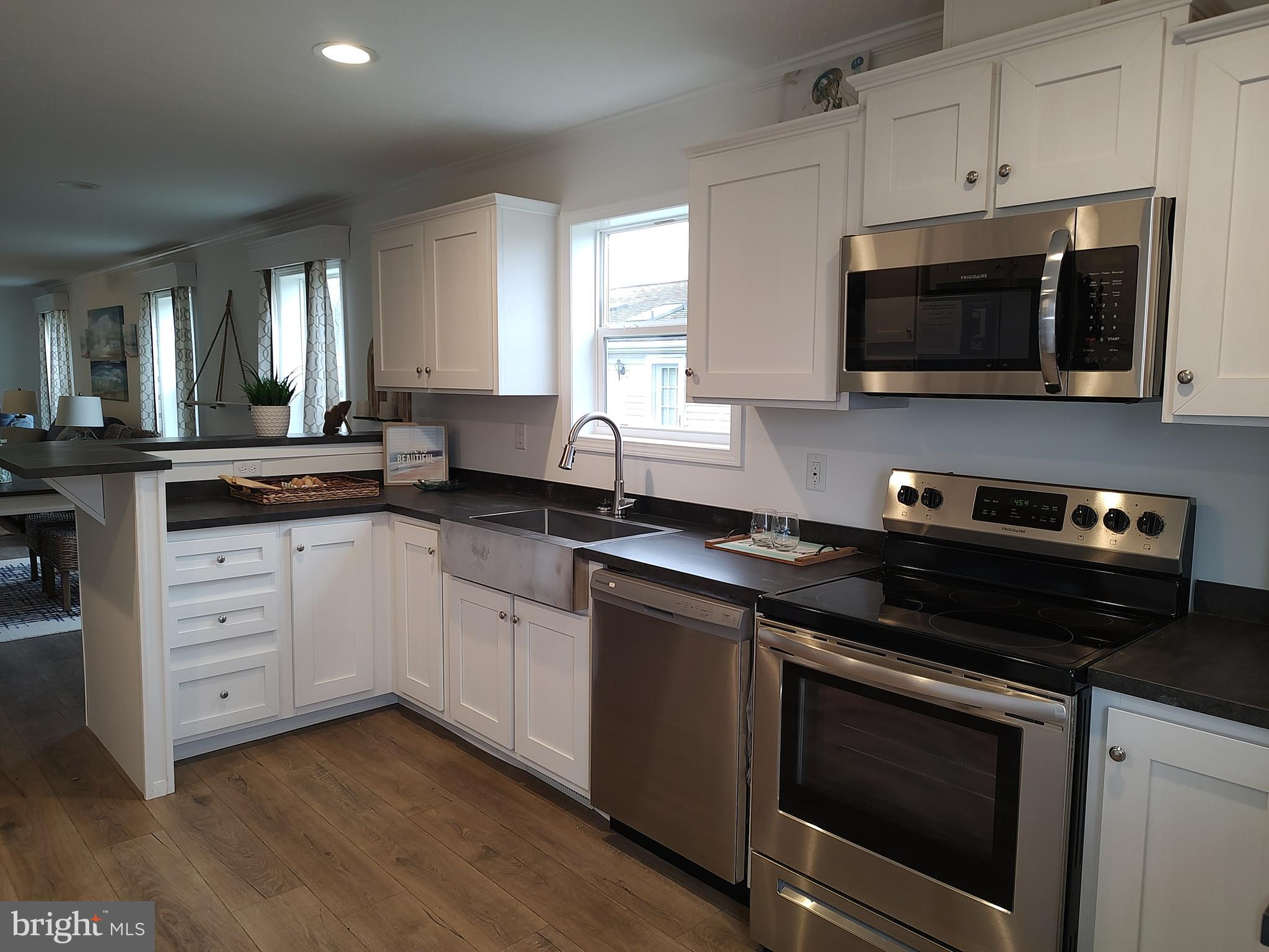3 Nottingham Drive Lewes, DE 19958 - Photo 15 of 26 a kitchen with stainless steel appliances a stove microwave and sink