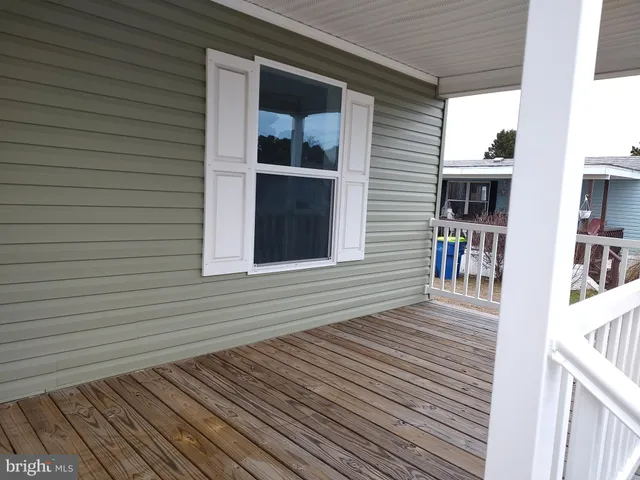 a view of a house with wooden deck