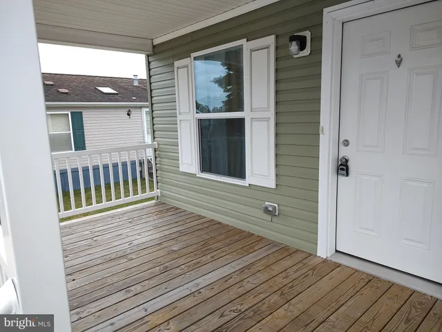 a view of a house with wooden deck