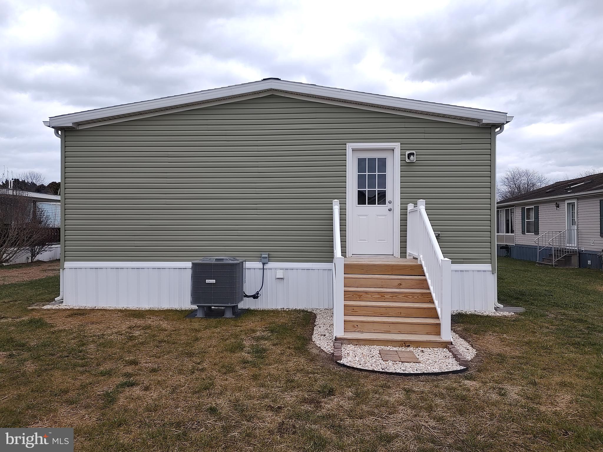 3 Nottingham Drive Lewes, DE 19958 - Photo 6 of 26 a front view of a house with a yard