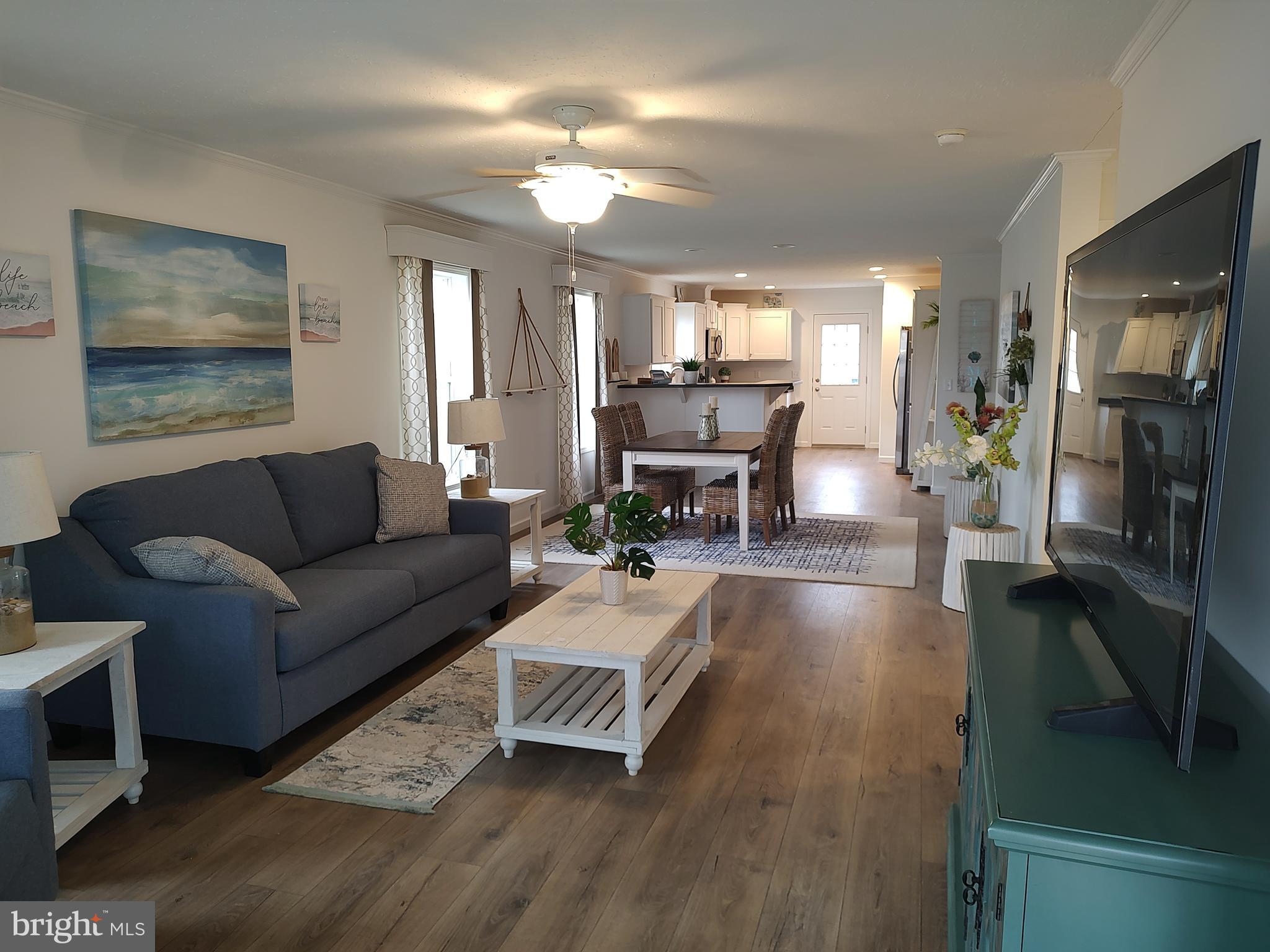 3 Nottingham Drive Lewes, DE 19958 - Photo 7 of 26 a living room with furniture and a flat screen tv