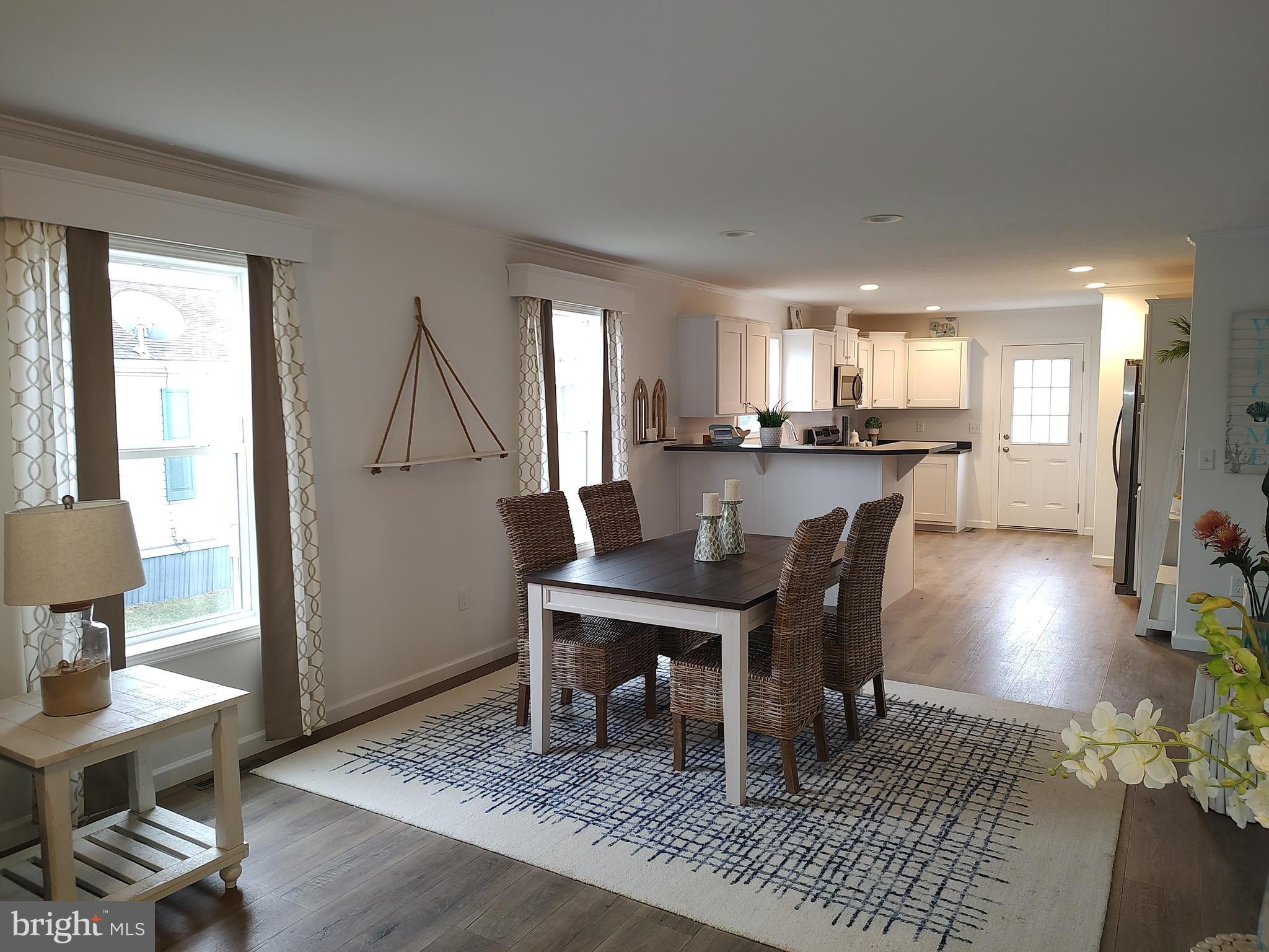 3 Nottingham Drive Lewes, DE 19958 - Photo 10 of 26 a view of a dining room with furniture and wooden floor