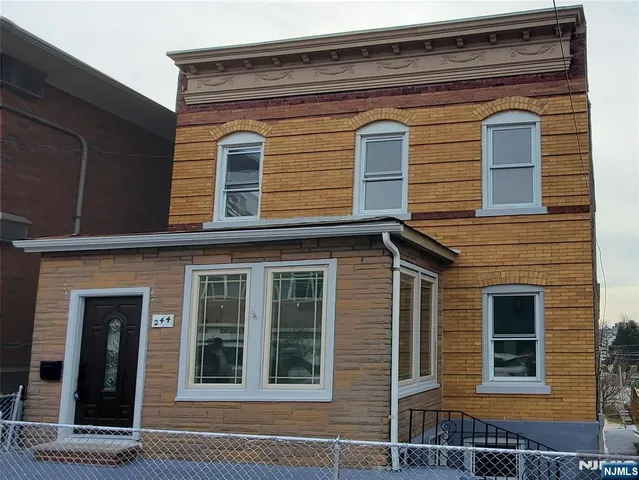 a view of a brick house with a large windows