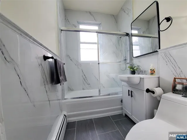 a view of a room with wooden floor and window