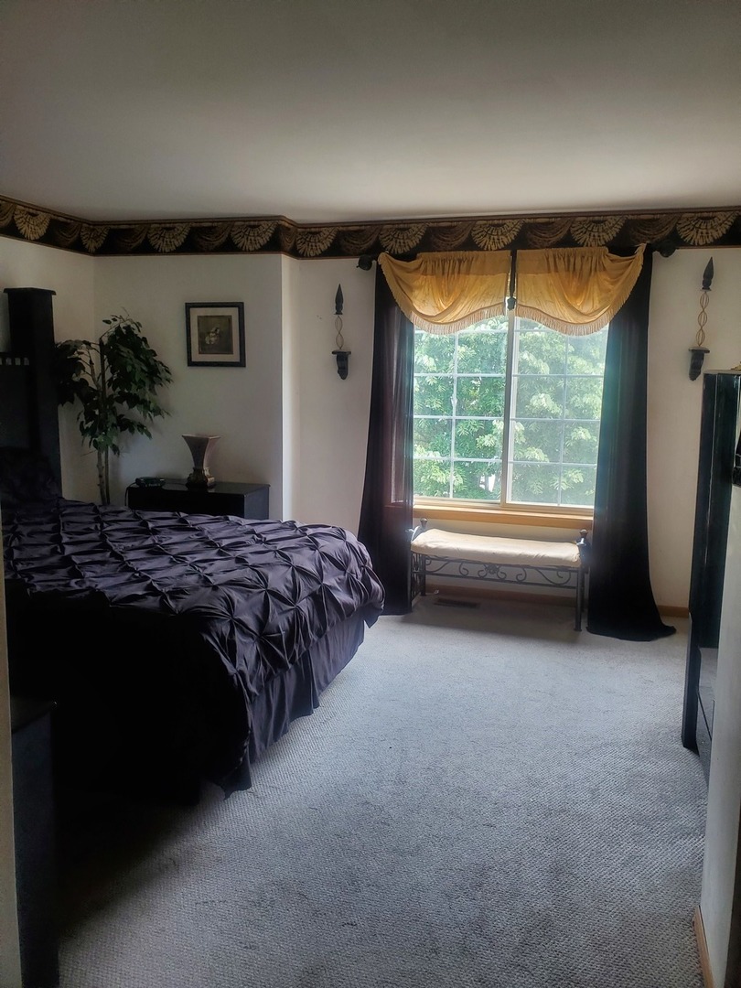 528 Alcott Lane Bolingbrook, IL 60440 - Photo 12 of 15 a bedroom with a bed and a large window