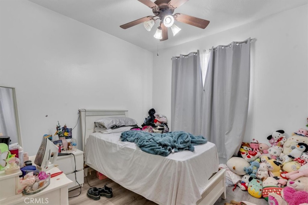 12008 Sierra Vista Road Phelan, CA 92371 - Photo 18 of 29 a bed room with a bed and a chandelier