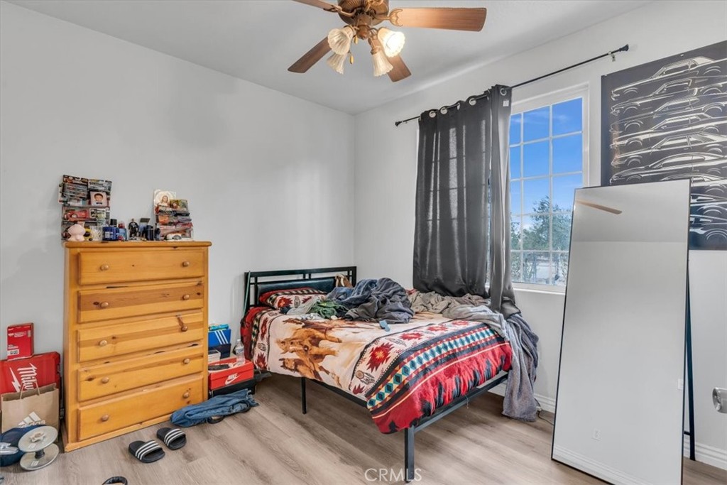 12008 Sierra Vista Road Phelan, CA 92371 - Photo 20 of 29 a bedroom with a bed and a dresser