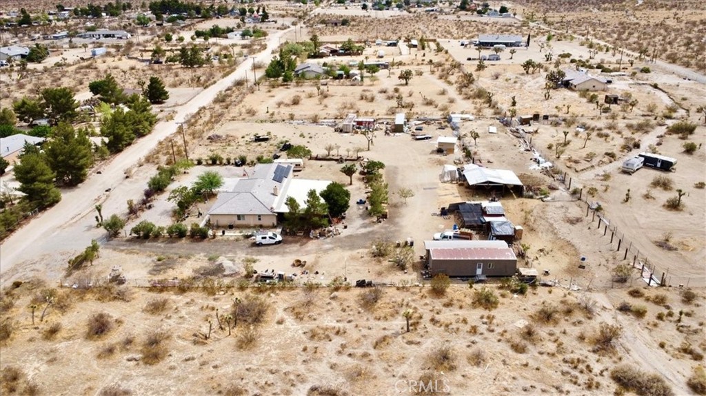 12008 Sierra Vista Road Phelan, CA 92371 - Photo 28 of 29 an aerial view of a house with a yard and large trees