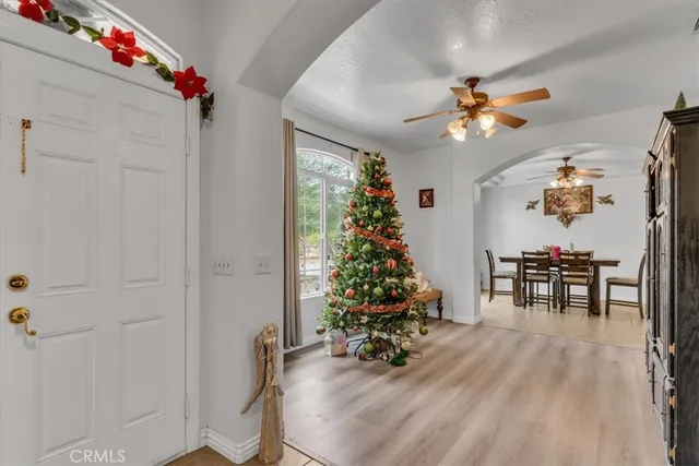 a view of a dining room with furniture and chandelier