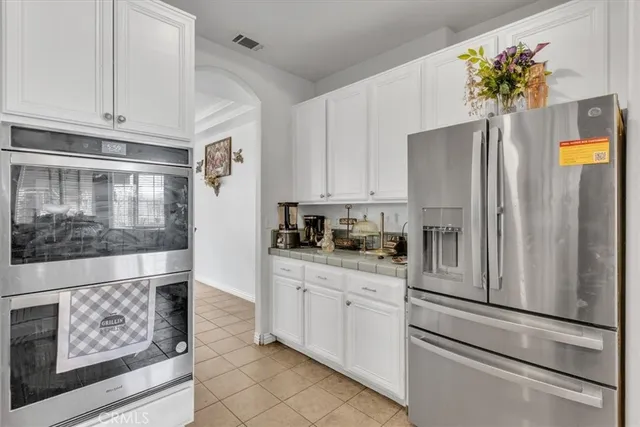 a kitchen with stainless steel appliances a refrigerator sink and cabinets